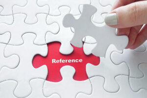 Reference als rotes Puzzleteil zwischen vielen weissen Puzzleteilen,Close,Up,Of,Girl's,Hand,Placing,The,Last,Jigsaw,Puzzle
